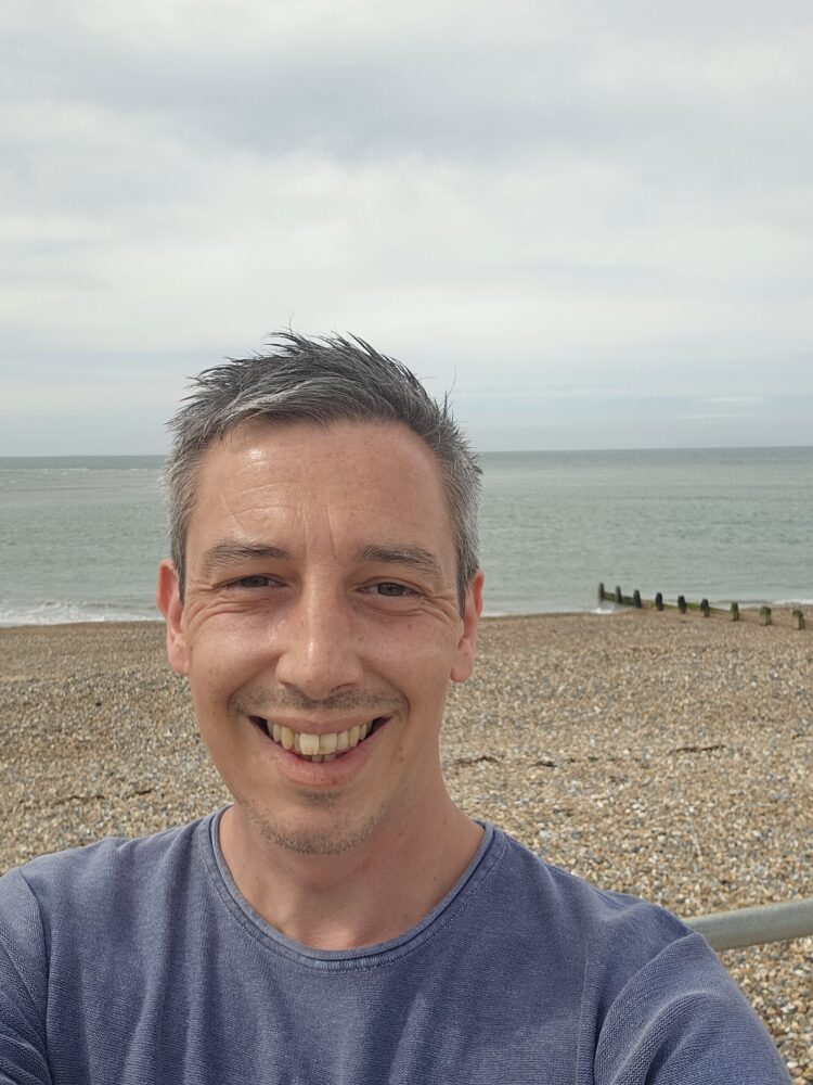 Tomos James Funeral Celebrant at Selsey pebble beach near Portsmouth, ideal for funeral celebrant services and personalized funerals.