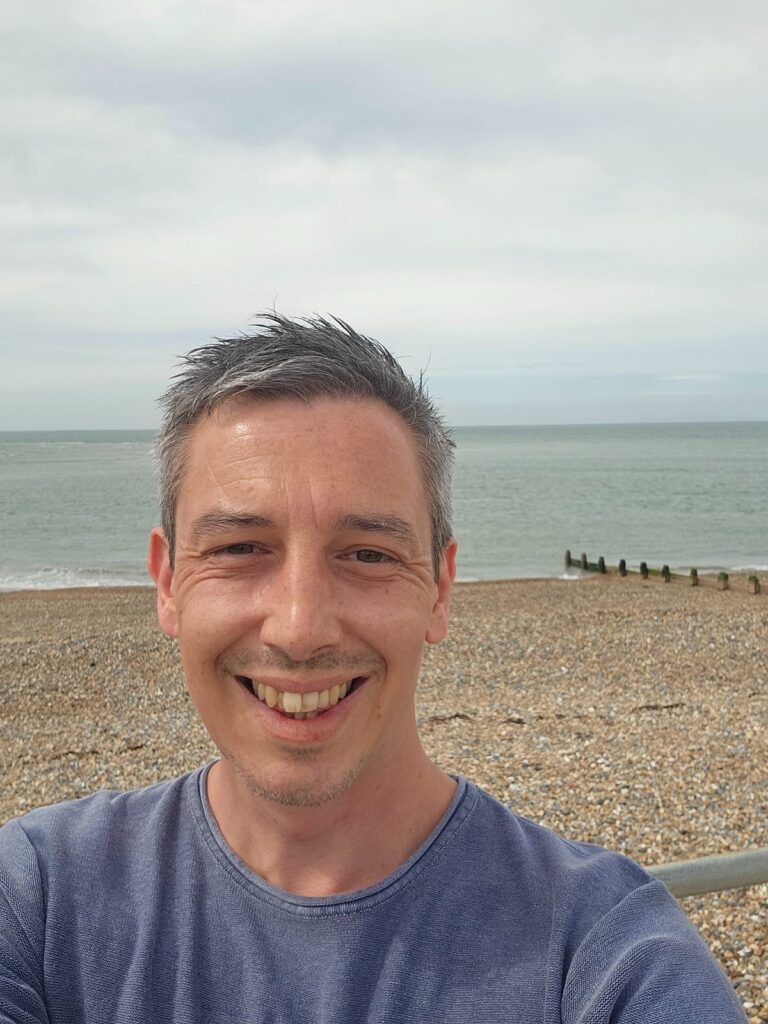 Tomos James Funeral Celebrant at Selsey pebble beach near Portsmouth, ideal for funeral celebrant services and personalized funerals.